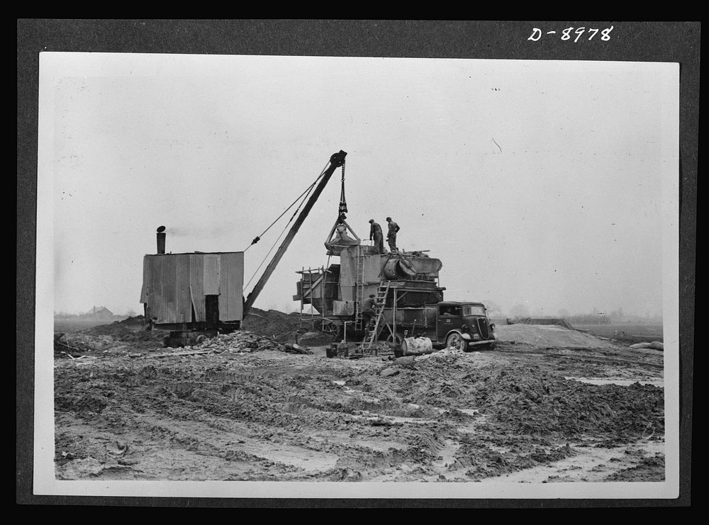 Reciprocal aid. Preparing an airfield in Britain for the U.S. Army Air Forces. British labor and material is used in the…