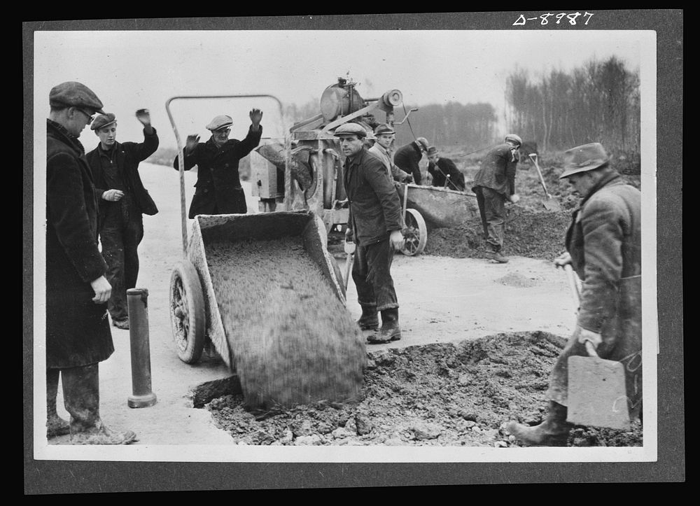 Reciprocal aid. Pouring concrete for runways for an airfield in Britain for the U.S. Army Air Forces. British labor and…