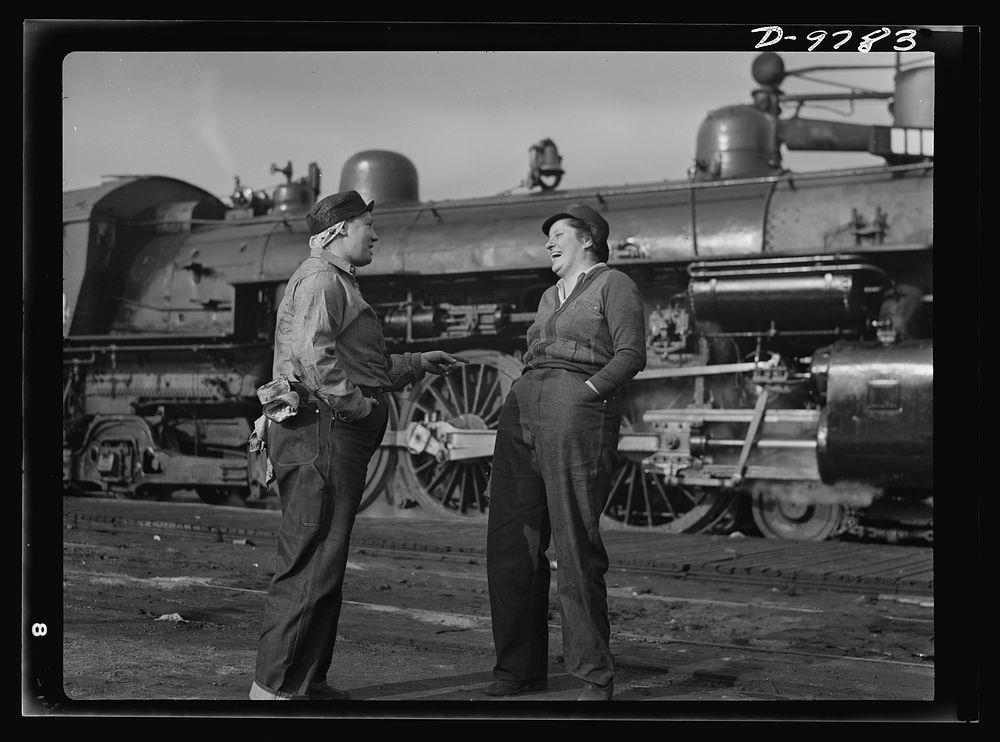 Women in essential services. Two women railroad workers enjoy a moment of relaxation from their new job in the yards of the…