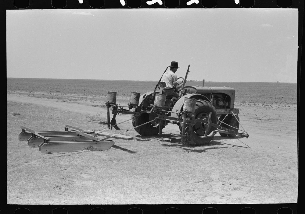 [Untitled photo, possibly related to: Tractor with planter and go-devil attached, large farm near Ralls, Texas] by Russell…