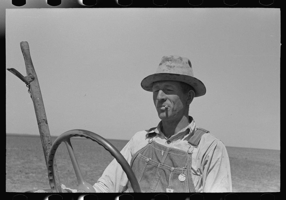 [Untitled photo, possibly related to: Day laborer adjusting plow points on tractor-drawn planter, near Ralls, Texas] by…