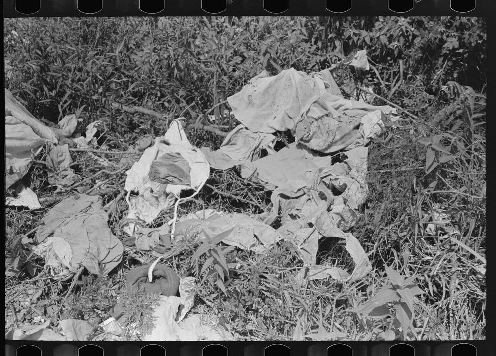 Clothes of white tenant farmer drying on the ground, McIntosh County, Oklahoma by Russell Lee