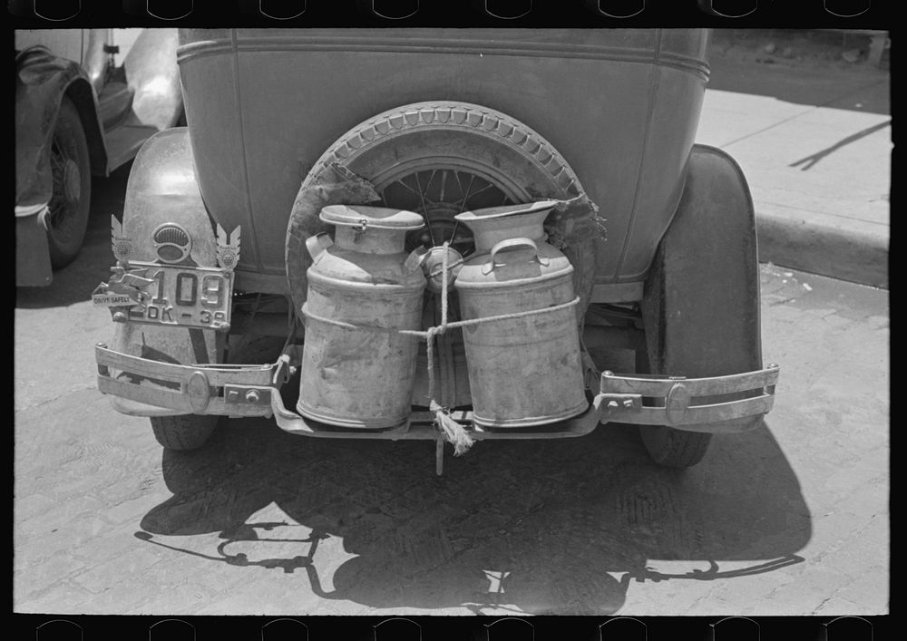 Milk cans tied on back of farm automobile, Muskogee, Oklahoma by Russell Lee