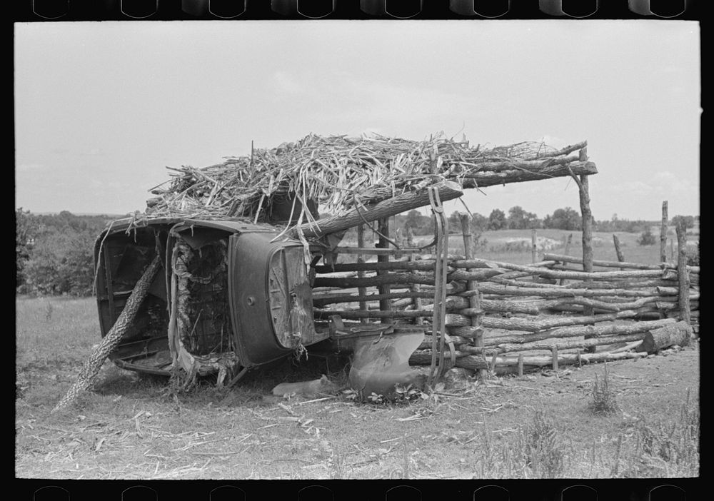 Hogpen of  tenant farmer held up by part of an automobile body, Wagoner County, Oklahoma by Russell Lee