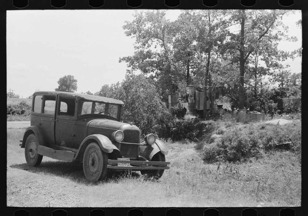 Automobile of family camped by the roadside while they did agricultural day labor in the neighborhood to secure funds to…