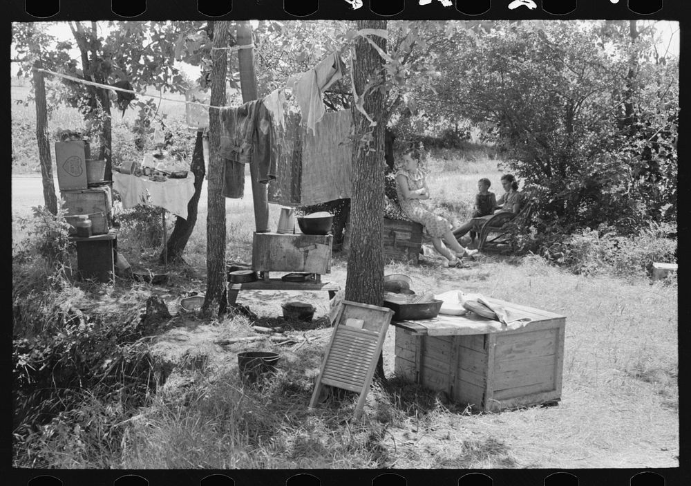 Camp by the roadside near Spiro, Oklahoma. This family did agricultural day labor to obtain funds to go to Arizona and…