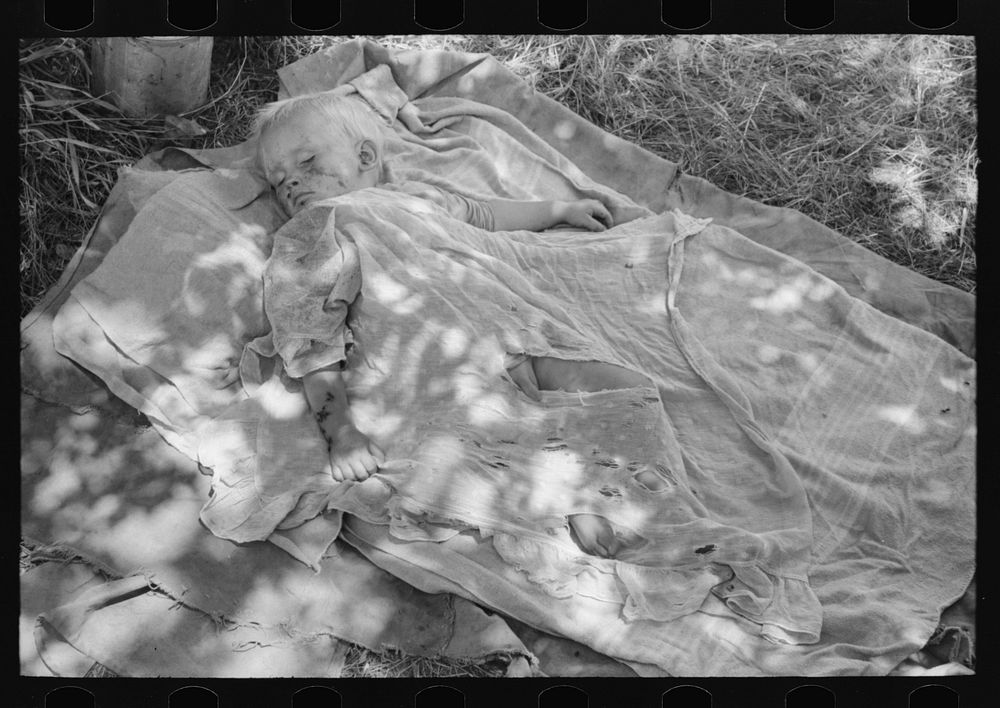 [Untitled photo, possibly related to: Child of family encamped by the roadside near Spiro, Oklahoma. This family is doing…