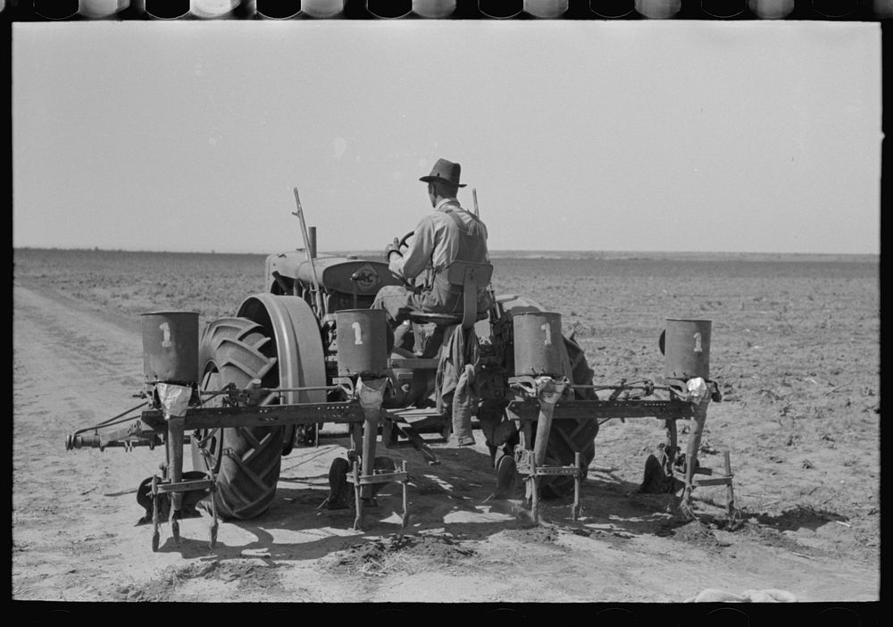Tractor with four-row planter, large farm near Ralls, Texas. This planter was fashioned and made by a smith from old horse…
