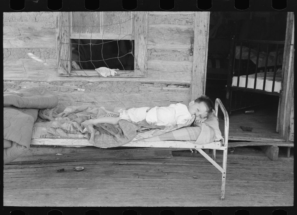 Child afflicted with tuberculosis of the spine in cast on porch of his home near Warner, Oklahoma. Tenant farm family by…