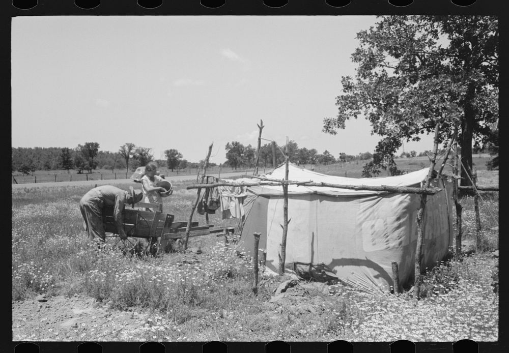 Camp of migratory workers who move along the road pushing their belongings in a cart, camped near Vian, Sequoyah County…