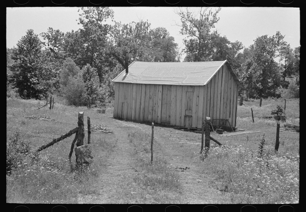 Home of agricultural day laborer near Sallisaw, Oklahoma. Notice absence of windows. Sequoyah County, Oklahoma by Russell Lee