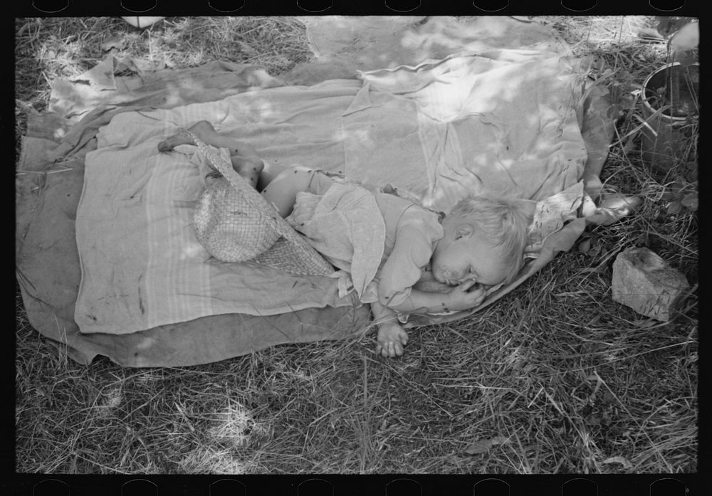 Baby of agricultural family camped by the roadside near Spiro. Sequoyah County, Oklahoma by Russell Lee