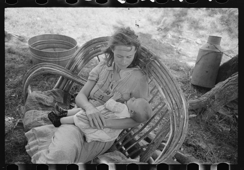 [Untitled photo, possibly related to: Wife and child of itinerant cane furniture maker and agricultural day laborer camped…