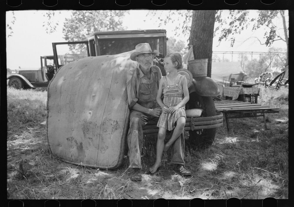 Veteran migrant agricultural worker with his daughter camped on Arkansas River, Wagon County, Oklahoma by Russell Lee