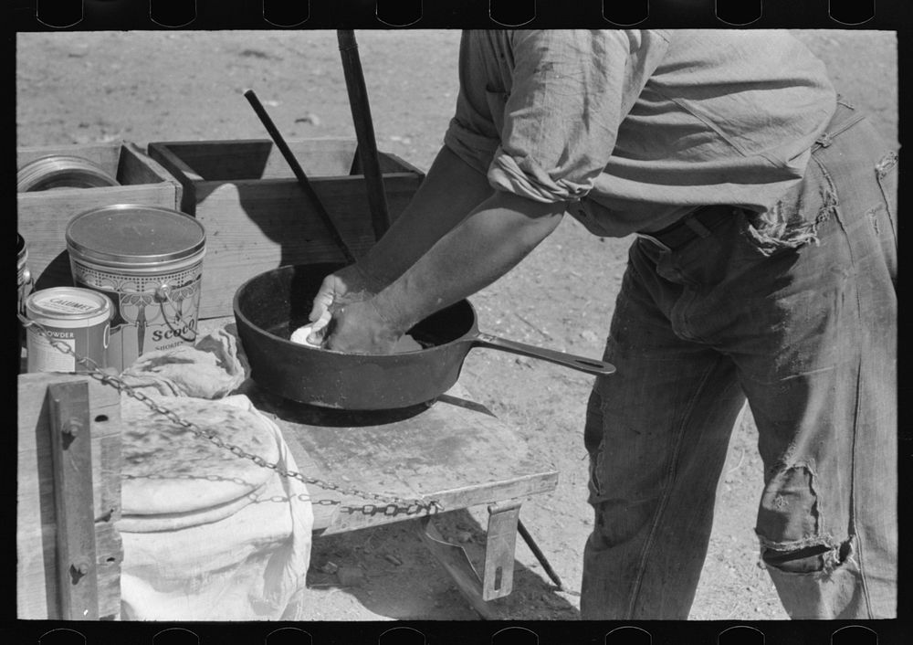 Placing bread in dutch oven to bake near Marfa, Texas by Russell Lee
