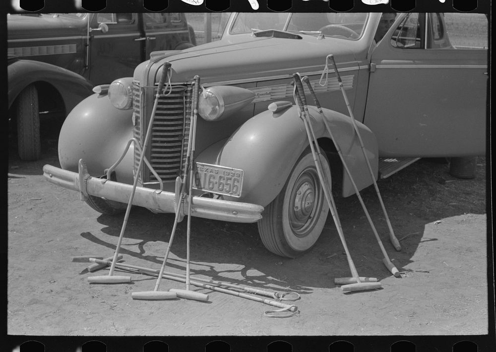 Polo mallets in front of automobile, Abilene, Texas by Russell Lee