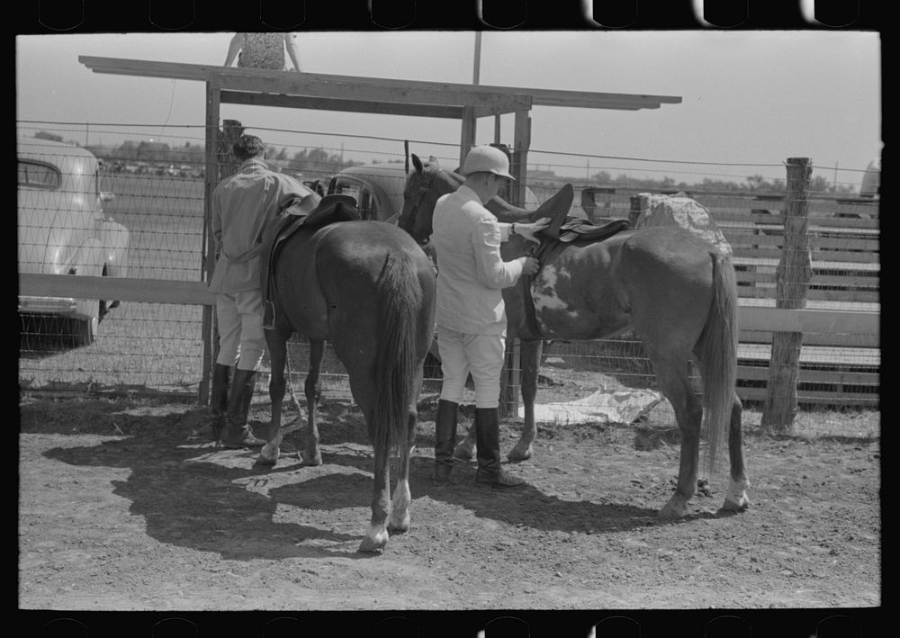 Harnessing ponies before polo match, Abilene, Texas by Russell Lee