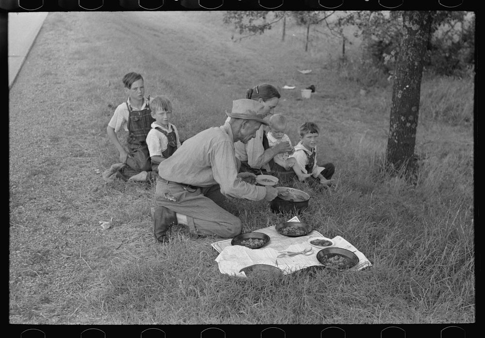 [Untitled photo, possibly related to: White migrant family eating lunch of berry pie on the highway east of Fort Gibson…