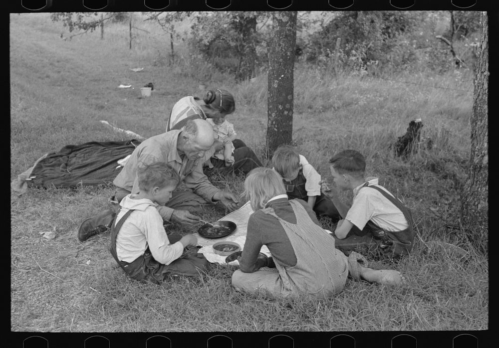 White migrant family eating lunch of berry pie on the highway east of Fort Gibson, Muskogee County, Oklahoma by Russell Lee
