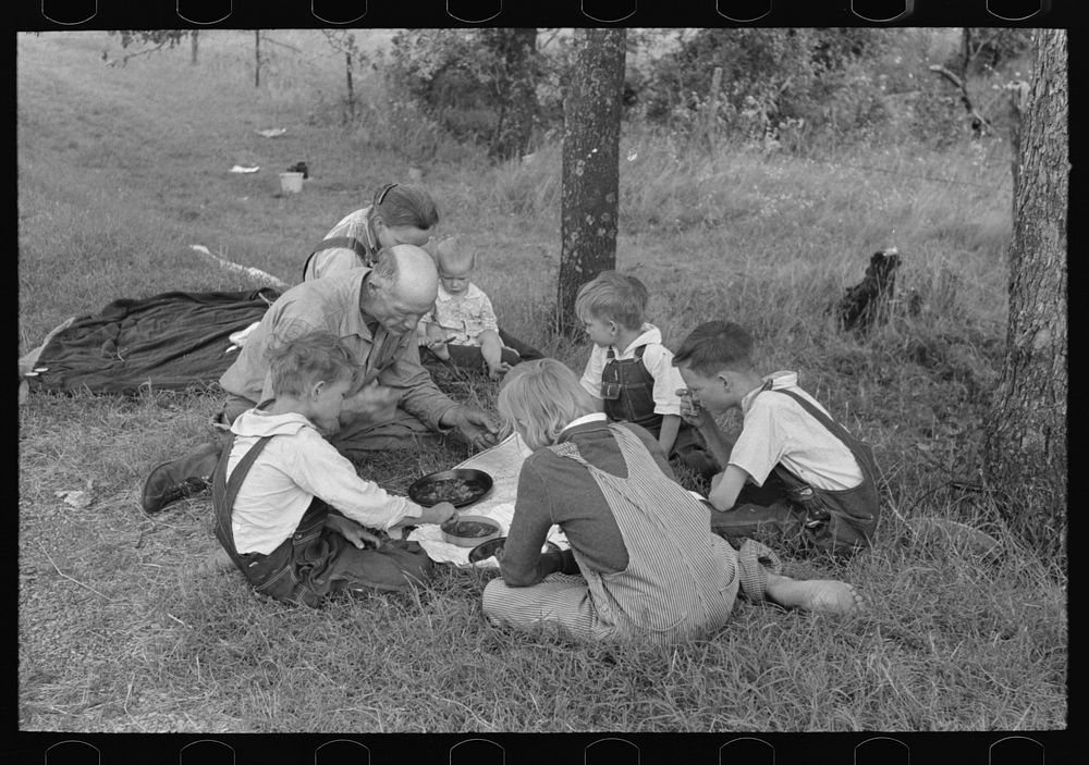[Untitled photo, possibly related to: White migrant family eating lunch of berry pie on the highway east of Fort Gibson…