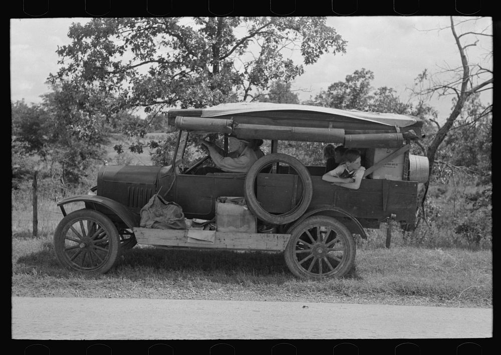 Family of white migrants in their automobile east of Fort Gibson, Muskogee County, Oklahoma by Russell Lee