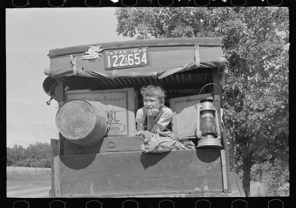 White migrant child sitting in back seat of family car east of Fort Gibson, Muskogee County, Oklahoma by Russell Lee
