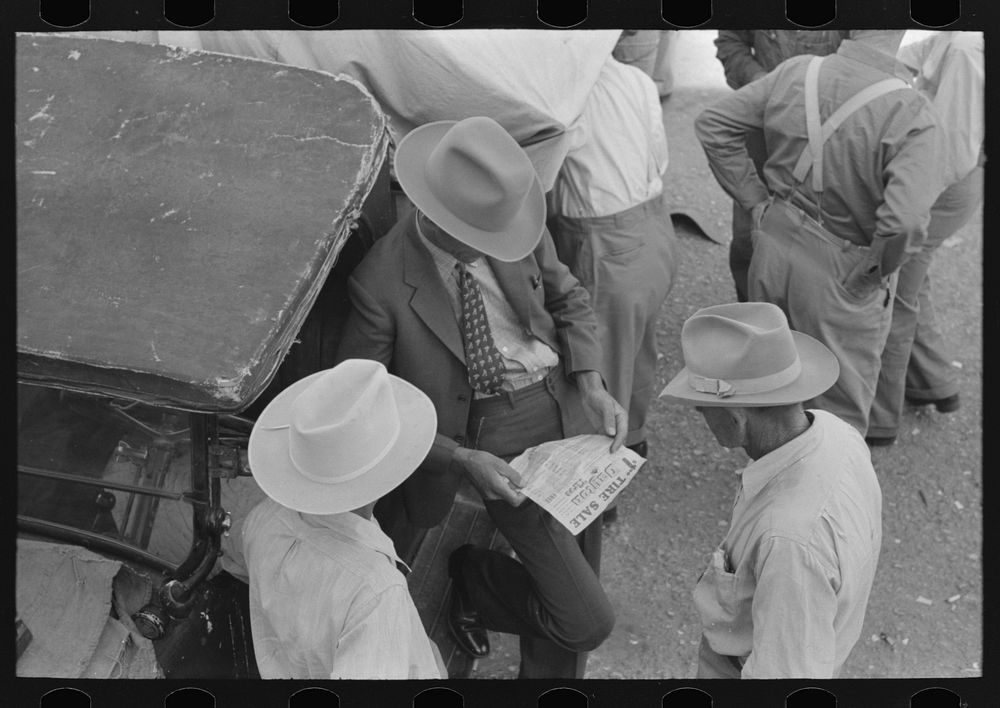 Farmers talking and looking at tire sale handbill, Weatherford, Texas by Russell Lee