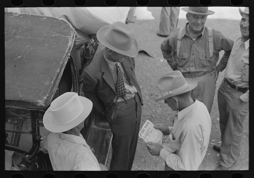 [Untitled photo, possibly related to: Farmers talking and looking at tire sale handbill, Weatherford, Texas] by Russell Lee