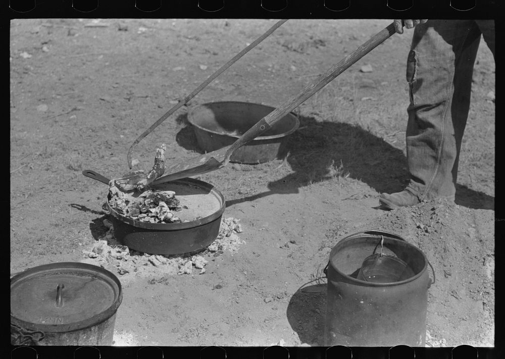 Placing coals on lid of dutch oven for baking bread. Roundup near Marfa, Texas by Russell Lee