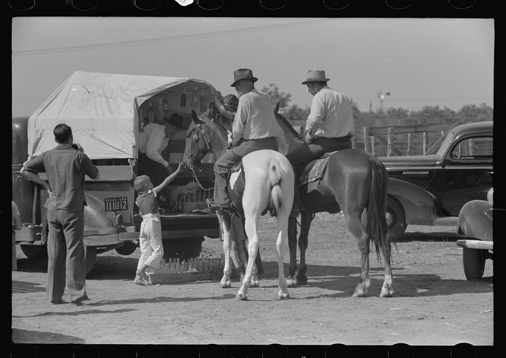 West Texans on their cow ponies buying soda pop at polo match, Abilene, Texas by Russell Lee