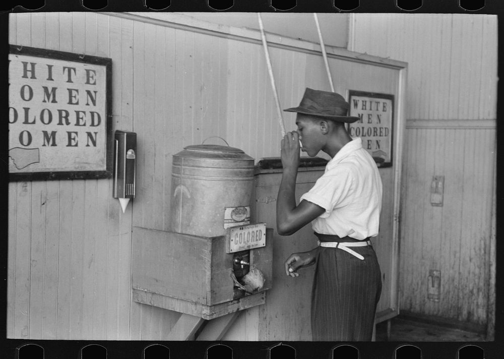  drinking at "Colored" water cooler in streetcar terminal, Oklahoma City, Oklahoma by Russell Lee