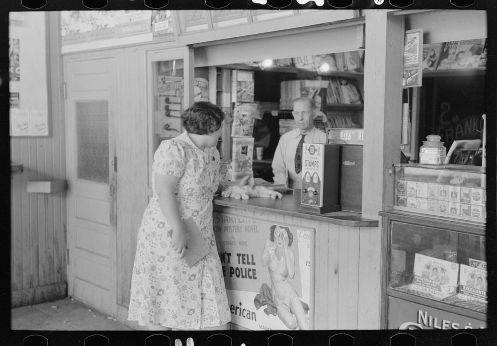 Tobacco stand keeper talking with woman. Streetcar terminal, Oklahoma City, Oklahoma by Russell Lee