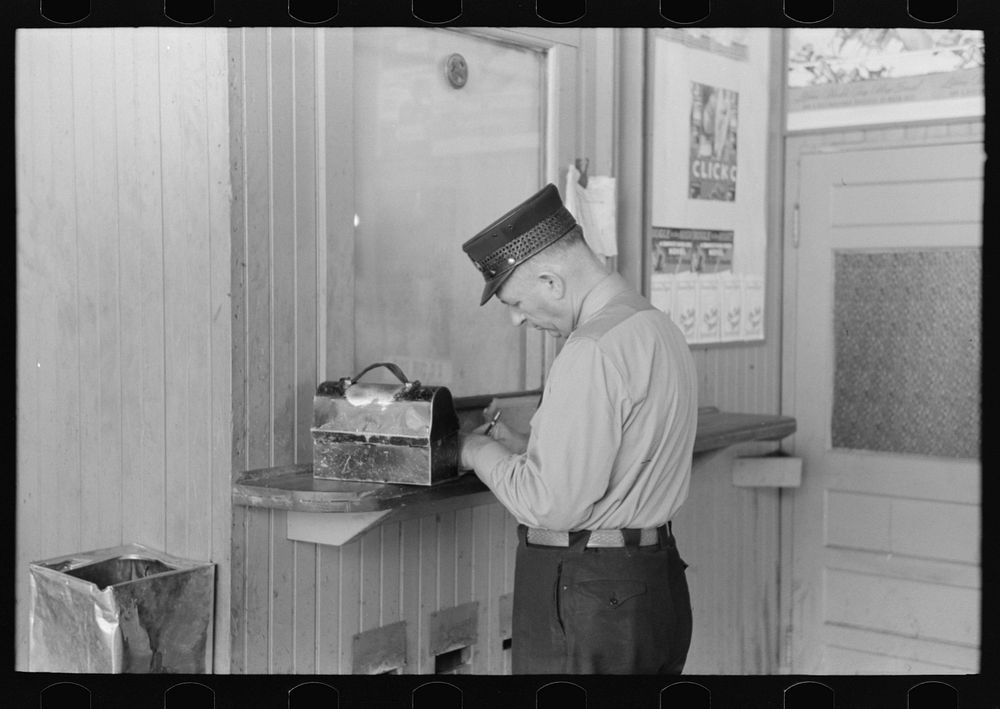 Motorman with lunch basket making out reports. Streetcar terminal, Oklahoma City, Oklahoma by Russell Lee