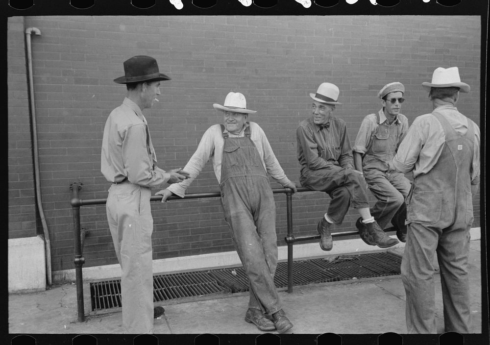 Men leaning and sitting on rail, Muskogee, Oklahoma by Russell Lee
