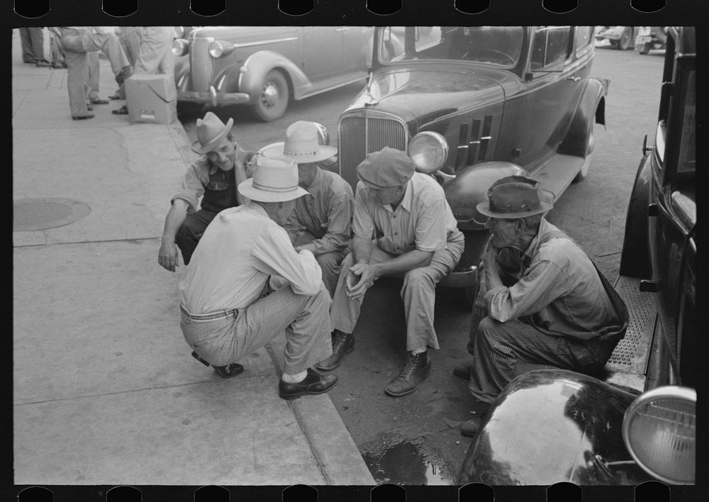 Group of men talking in street of Muskogee, Oklahoma by Russell Lee