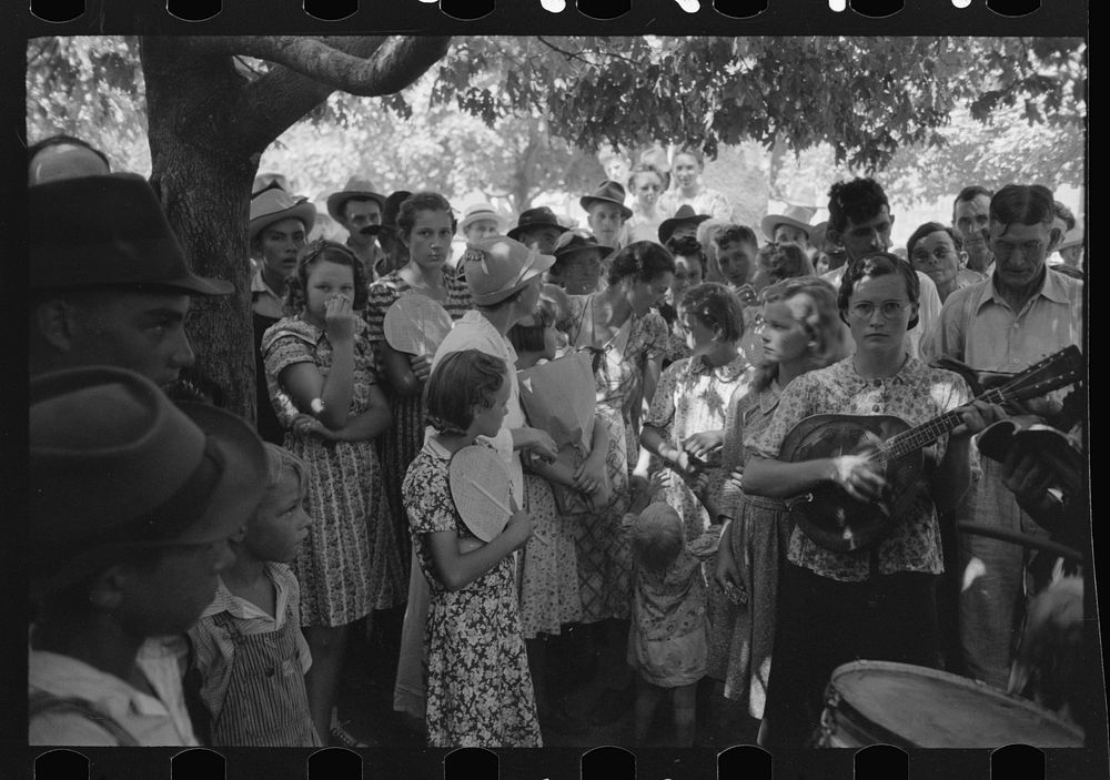 Group of people assembled under tree to listen to revival rally on Saturday afternoon, Tahlequah, Oklahoma by Russell Lee