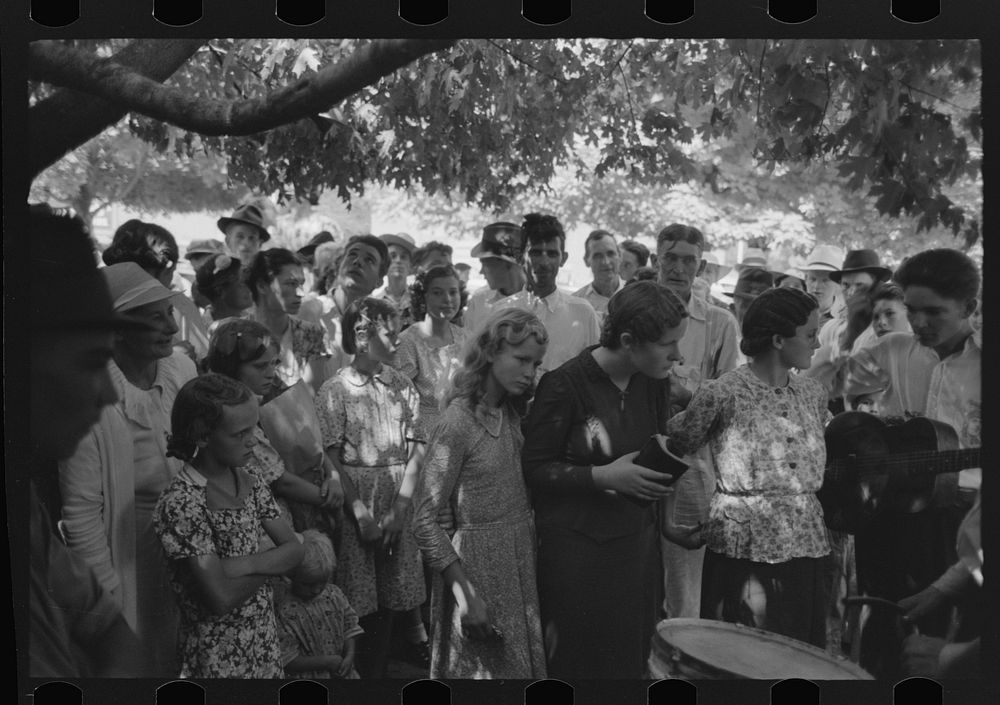 Revivalist surrounded by speculators at rally under trees in square, Saturday afternoon, Tahlequah, Oklahoma by Russell Lee