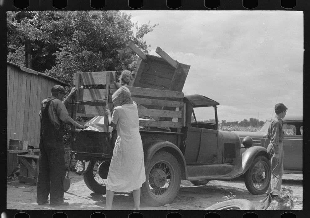 [Untitled photo, possibly related to: Loading truck with table which will be carried by this migrant family to California…