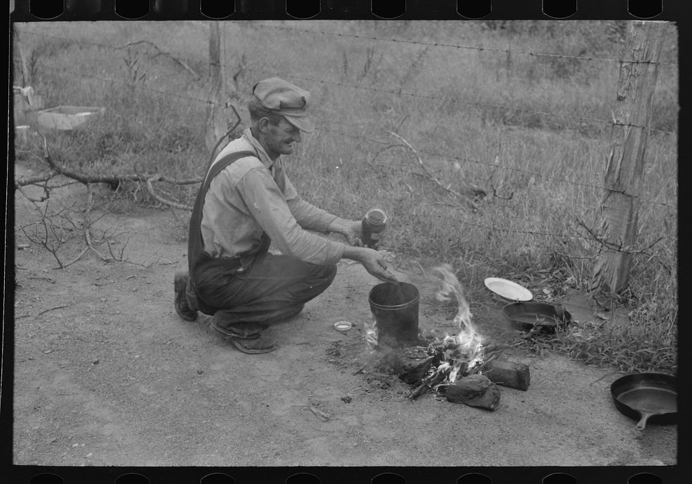 Elmer Thomas, migrant to California, preparing coffee along the roadside near Henrietta [i.e., Henryetta,] Oklahoma by…