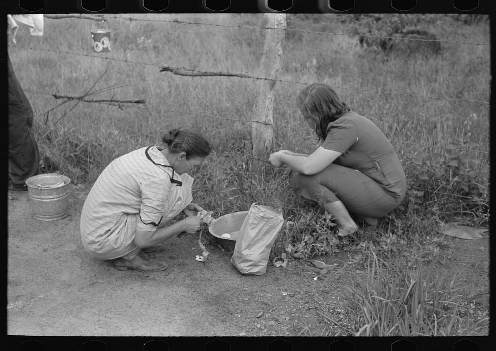 Women of a migrant family peeling potatoes near Henrietta [i.e., Henryetta,] Oklahoma by Russell Lee
