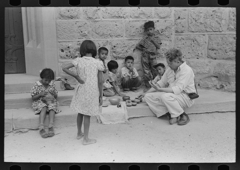 Tourist buying Indian pottery from children at Tesuque pueblo, New Mexico by Russell Lee