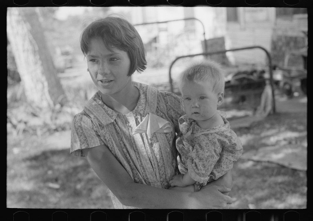 Young girl holding baby brother in her arms, community camp, Oklahoma City Oklahoma by Russell Lee