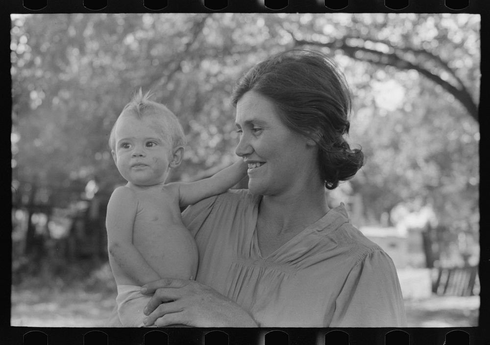 Wife of carpenter and her baby who live in community camp, Oklahoma City, Oklahoma by Russell Lee
