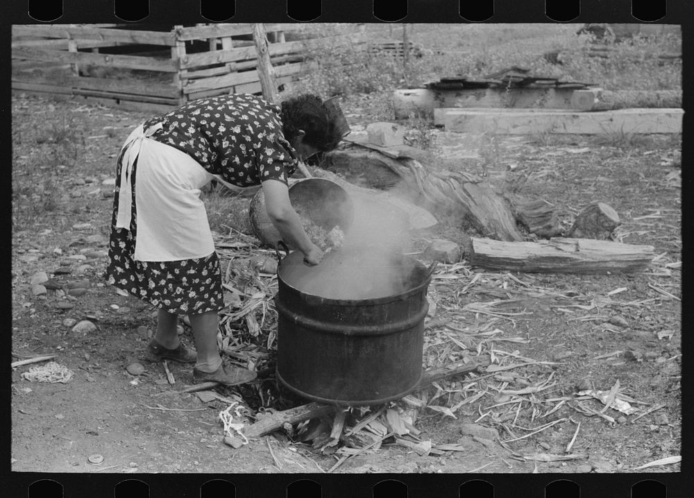 [Untitled photo, possibly related to: Spanish-American FSA (Farm Security Administration) client emptying pail of grease…