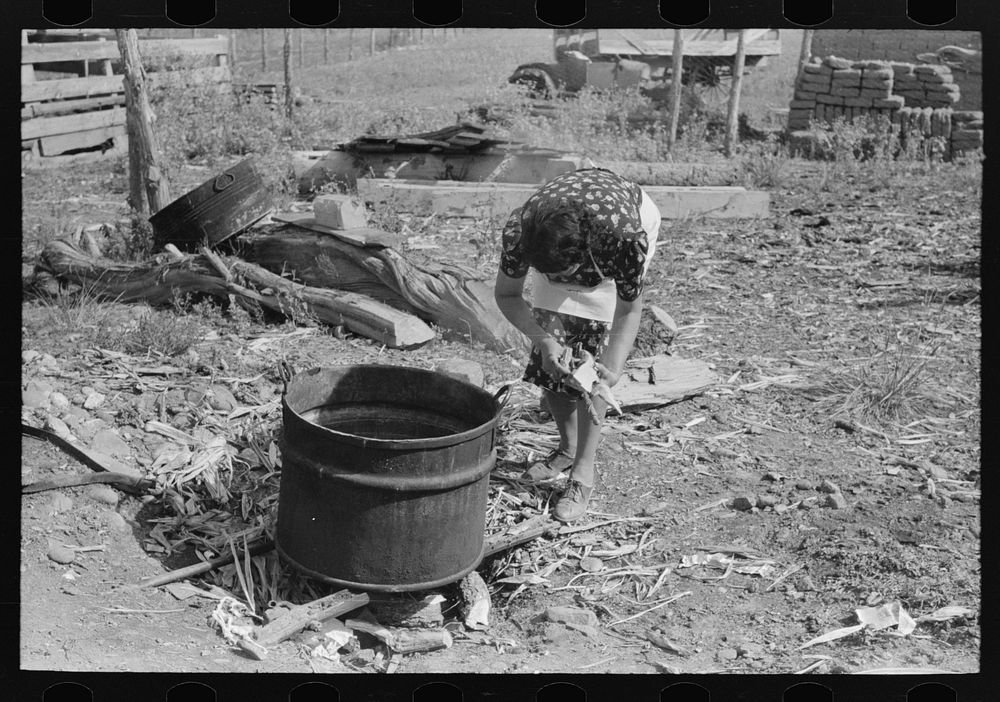 Spanish-American FSA (Farm Security Administration) client building fire under soap kettle, Taos County, New Mexico by…