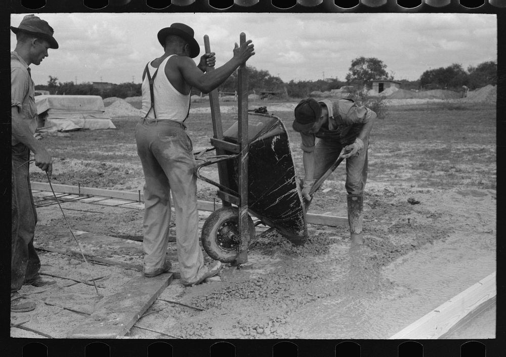 Pouring concrete at migrant camp under construction at Sinton, Texas by Russell Lee