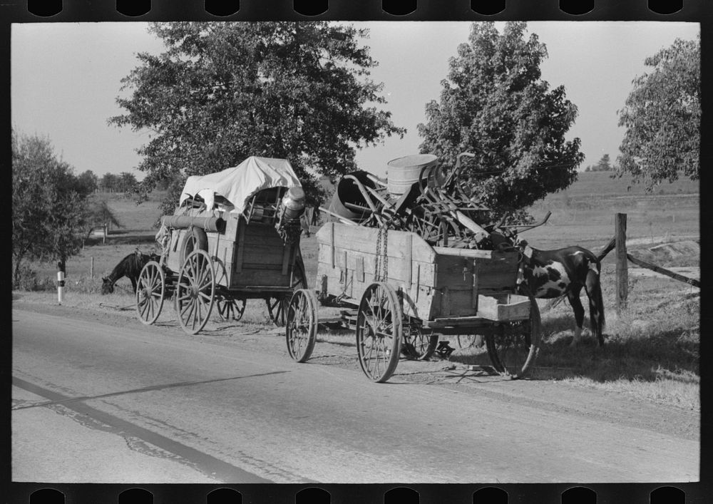 [Untitled photo, possibly related to: Farmer moving in wagon from farm to a new farm. He had stopped for rest and repair…