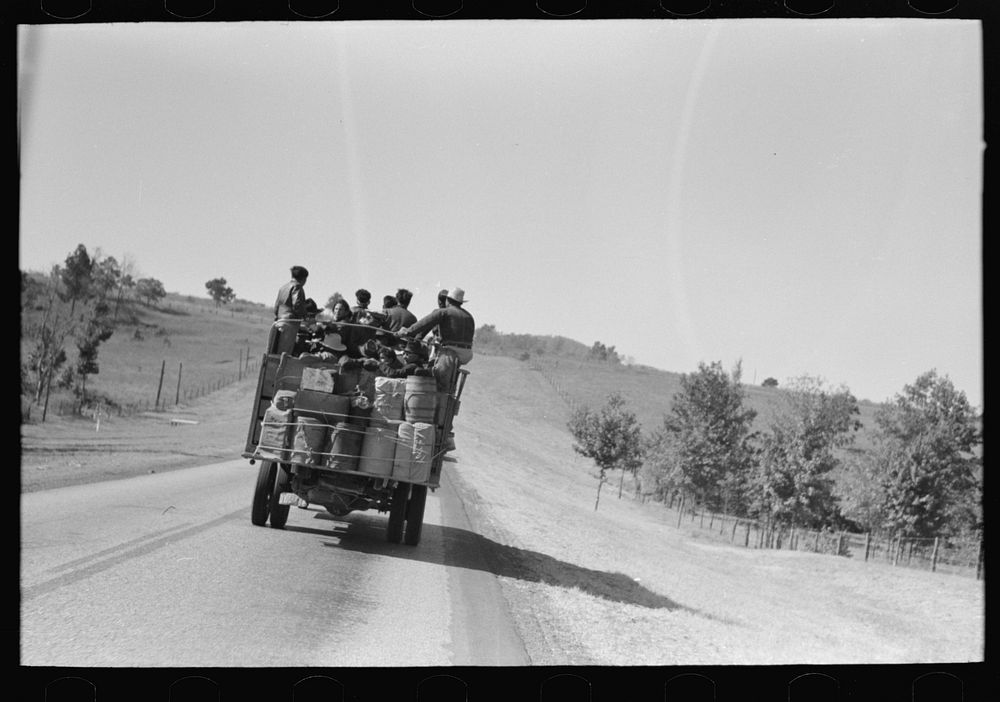 Truckload of Mexican migrants returning from Mississippi where they had been picking cotton. Highway near Neches, Texas…