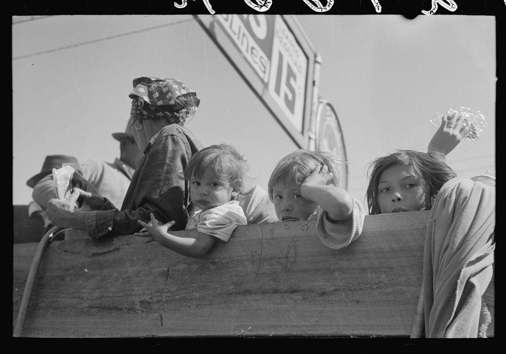 [Untitled photo, possibly related to: Mexican woman and children looking over side of truck which is taking them to their…