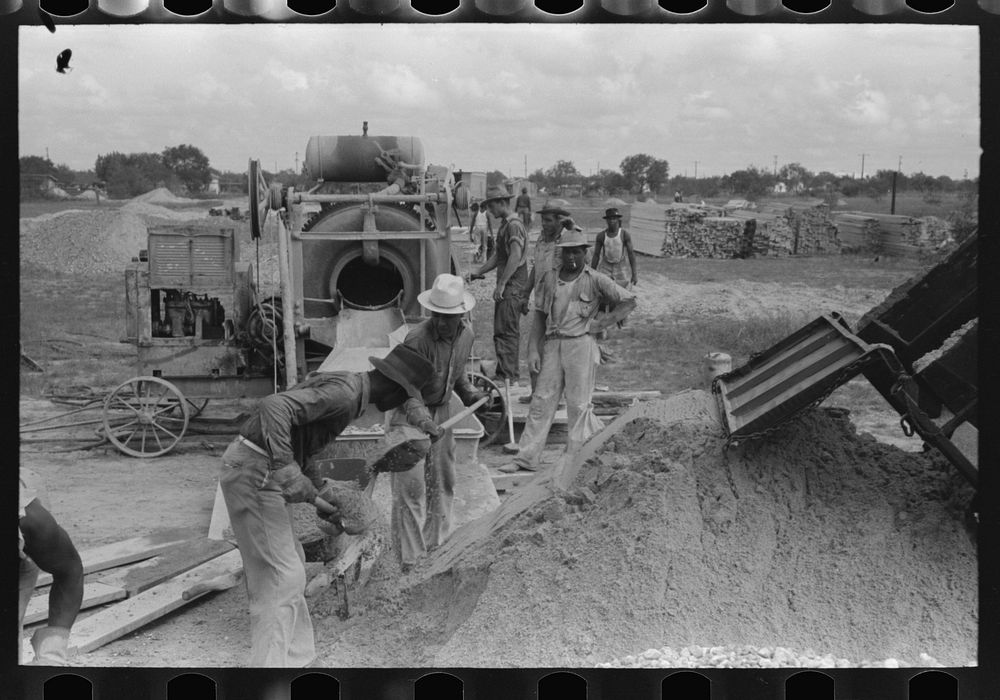 Activity around concrete mixer at migrant camp under construction at Sinton, Texas by Russell Lee